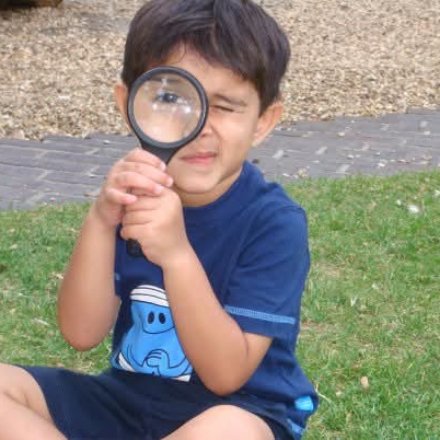 A curious child exploring with a magnifying glass